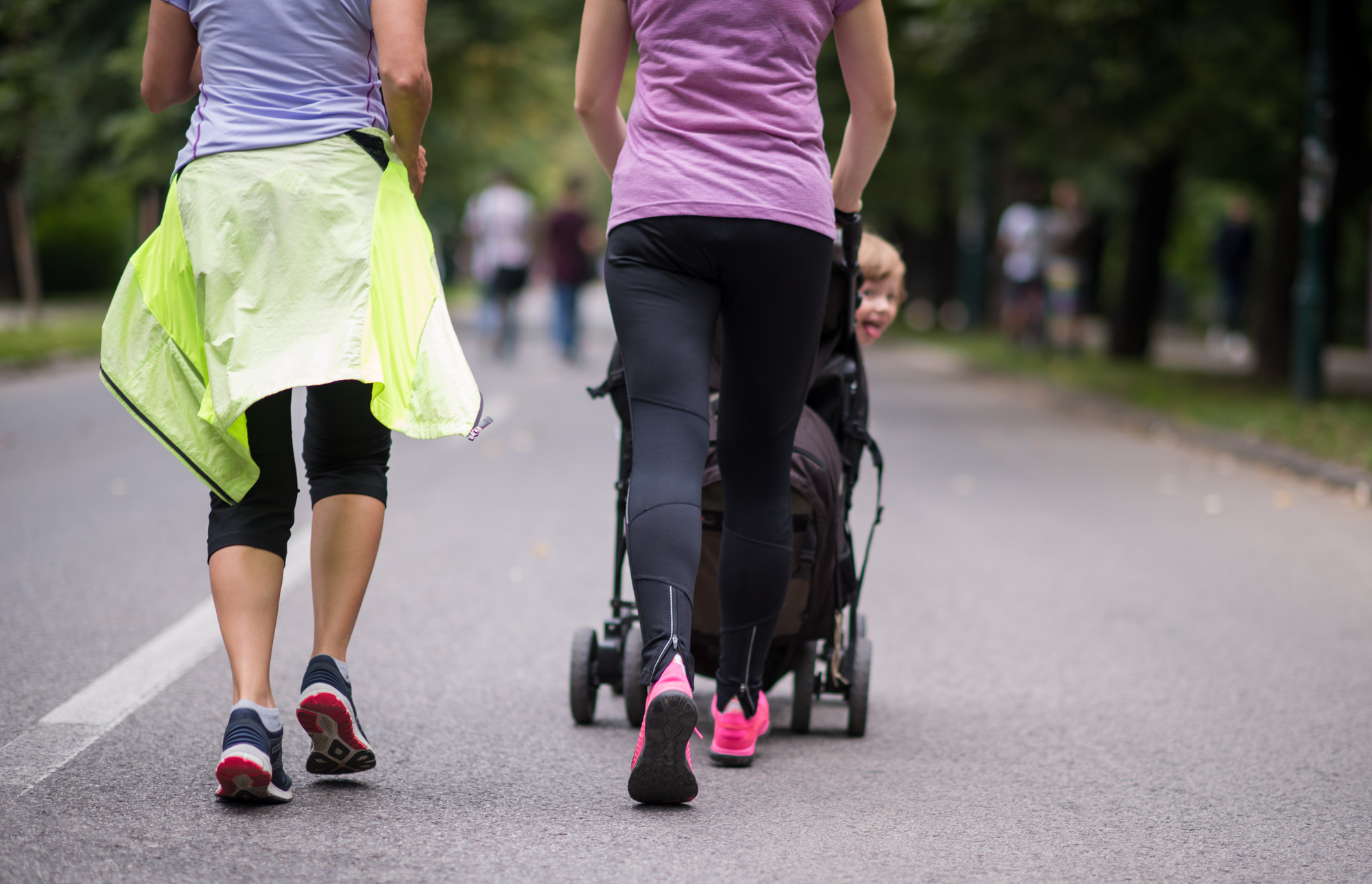 Women with Baby Stroller Jogging Together